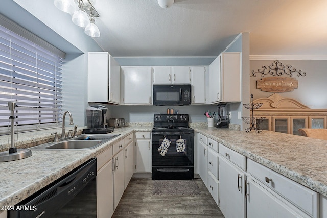 kitchen featuring white cabinets, ornamental molding, dark hardwood / wood-style floors, black appliances, and sink