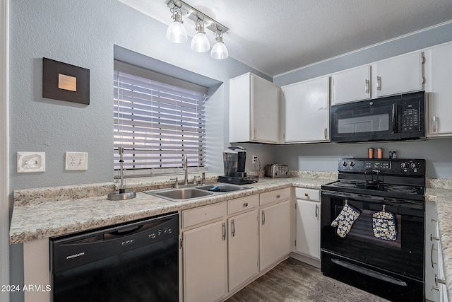 kitchen featuring white cabinets, a textured ceiling, black appliances, light hardwood / wood-style floors, and sink