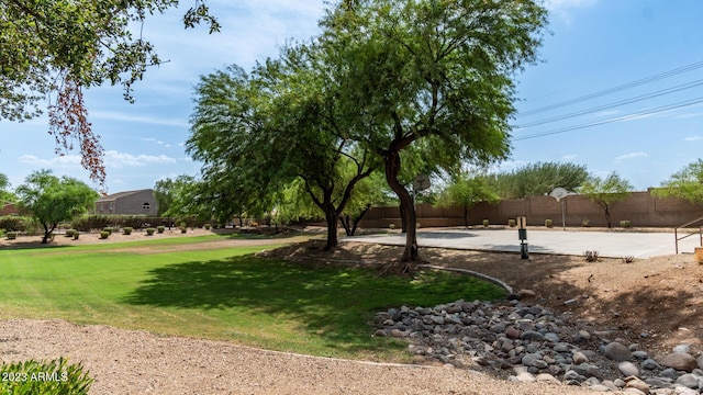 view of community with a yard and basketball court