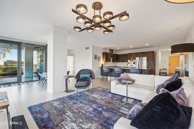 living room with a chandelier and light tile patterned floors