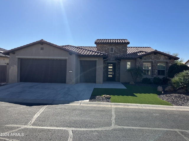 view of front facade with a garage and a front lawn