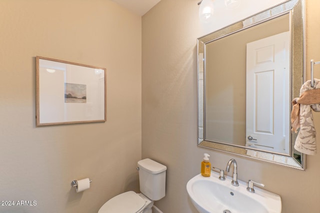 bathroom featuring toilet and sink