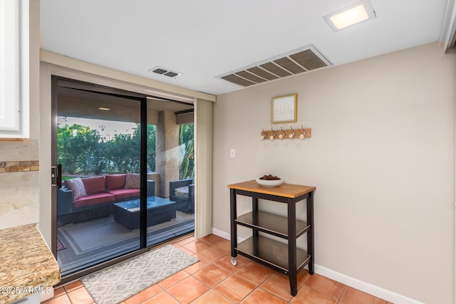 doorway with light tile patterned floors