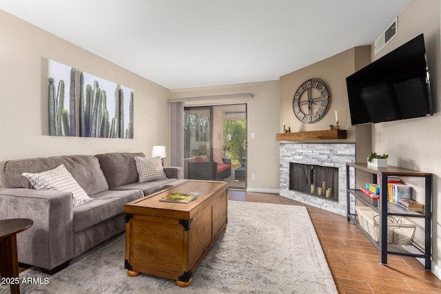 living room with a fireplace and wood-type flooring