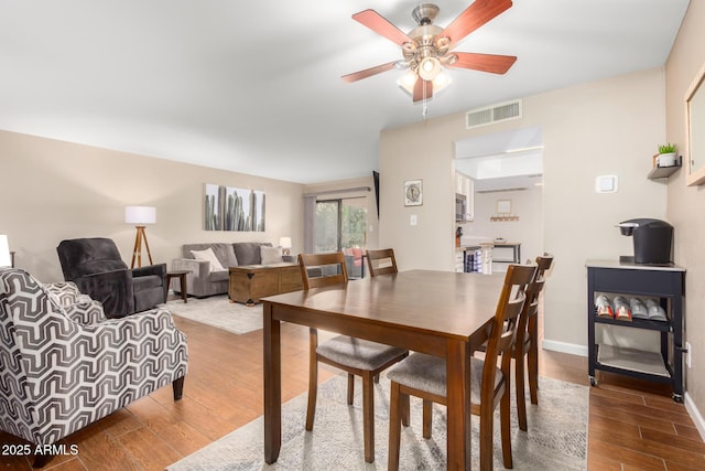 dining space featuring hardwood / wood-style floors and ceiling fan