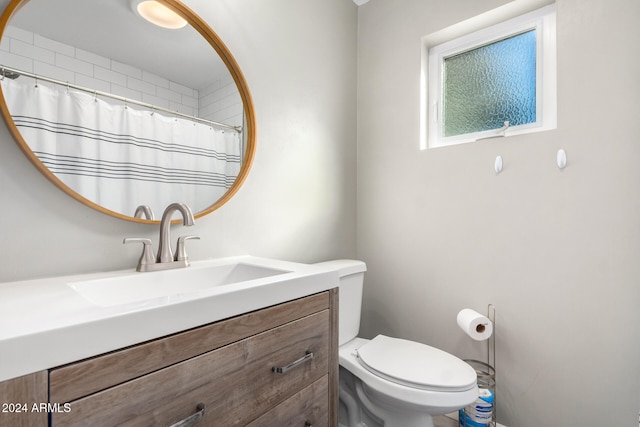 bathroom featuring toilet and vanity