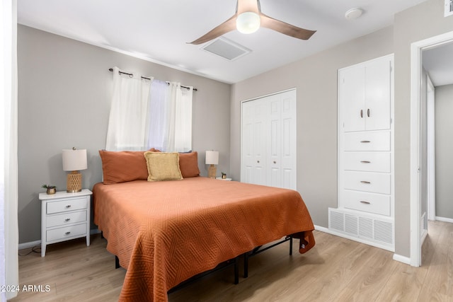 bedroom featuring light hardwood / wood-style flooring, a closet, and ceiling fan