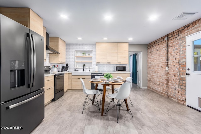 kitchen with sink, light brown cabinets, stainless steel appliances, and light wood-type flooring