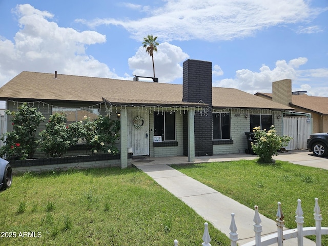 4507 E Saint Catherine Ave, Phoenix, AZ 85042 - single story home with a shingled roof, a chimney, and brick siding