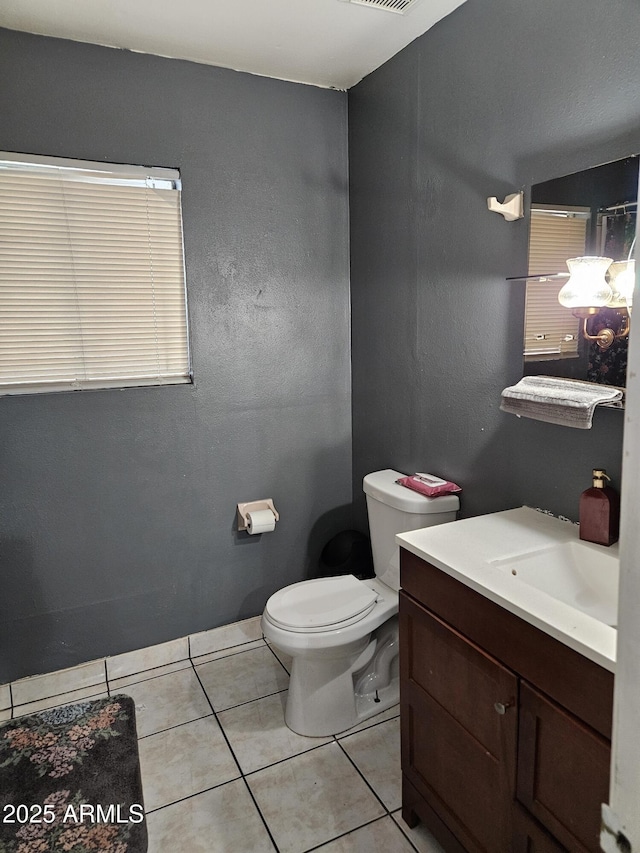 4507 E Saint Catherine Ave, Phoenix, AZ 85042 - half bathroom featuring tile patterned floors, toilet, and vanity
