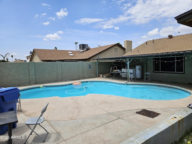4507 E Saint Catherine Ave, Phoenix, AZ 85042 - view of swimming pool featuring central AC, a patio, and a fenced backyard