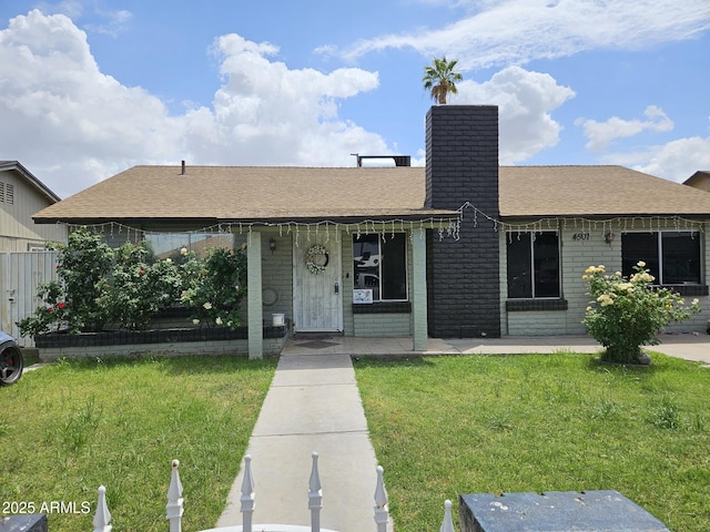 4507 E Saint Catherine Ave, Phoenix, AZ 85042 - ranch-style home featuring a front lawn, a chimney, brick siding, a shingled roof, and covered porch
