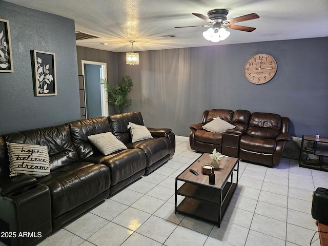 4507 E Saint Catherine Ave, Phoenix, AZ 85042 - living area with a ceiling fan, a textured wall, and light tile patterned flooring