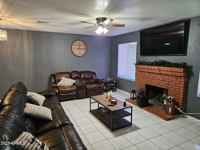 4507 E Saint Catherine Ave, Phoenix, AZ 85042 - living area featuring light tile patterned flooring, ceiling fan, a brick fireplace, and a chandelier