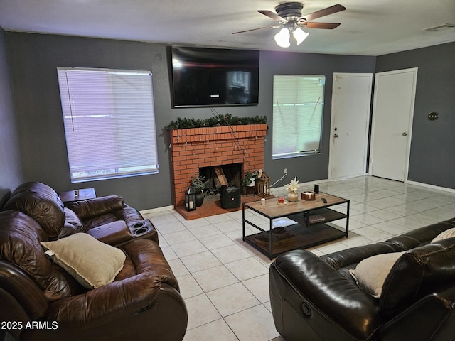 4507 E Saint Catherine Ave, Phoenix, AZ 85042 - living area featuring light tile patterned floors, a ceiling fan, a fireplace, and baseboards