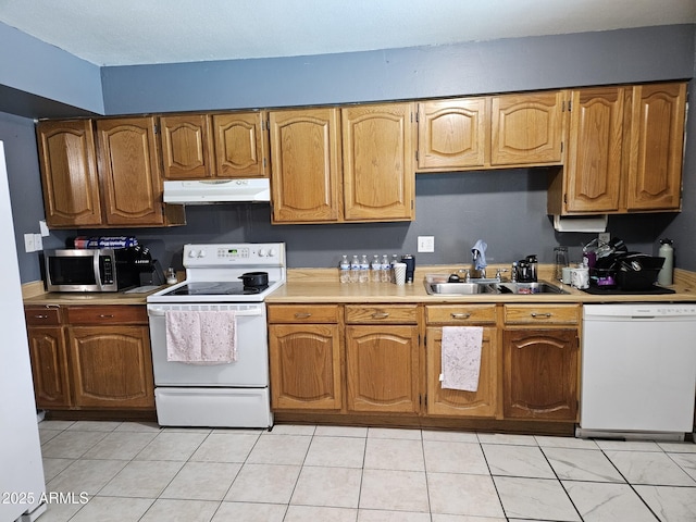 4507 E Saint Catherine Ave, Phoenix, AZ 85042 - kitchen with white appliances, under cabinet range hood, a sink, and light countertops