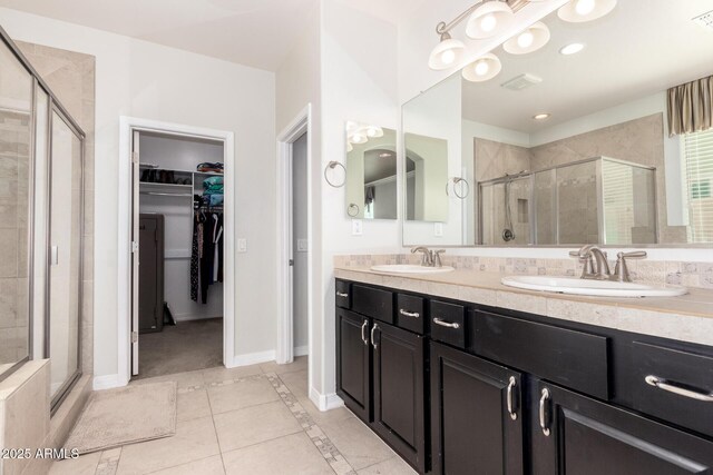 20709 W Delaney Dr, Buckeye, AZ 85396 - full bathroom with a spacious closet, a shower stall, tile patterned flooring, and double vanity