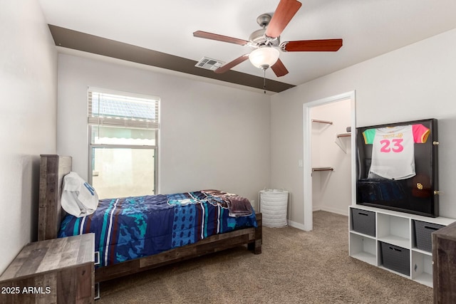 20709 W Delaney Dr, Buckeye, AZ 85396 - carpeted bedroom featuring a walk in closet and a ceiling fan
