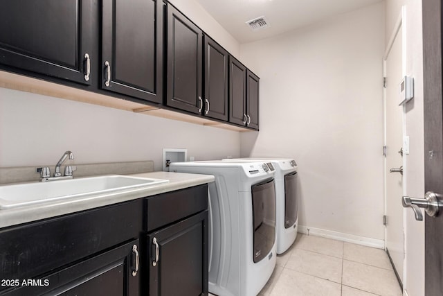 20709 W Delaney Dr, Buckeye, AZ 85396 - laundry room featuring cabinet space, washer and dryer, and light tile patterned flooring