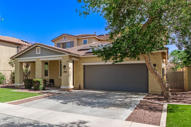 20709 W Delaney Dr, Buckeye, AZ 85396 - view of front of house with roof mounted solar panels, an attached garage, stucco siding, and driveway
