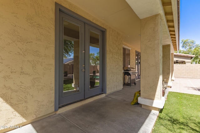 20709 W Delaney Dr, Buckeye, AZ 85396 - property entrance featuring french doors, a patio area, and stucco siding