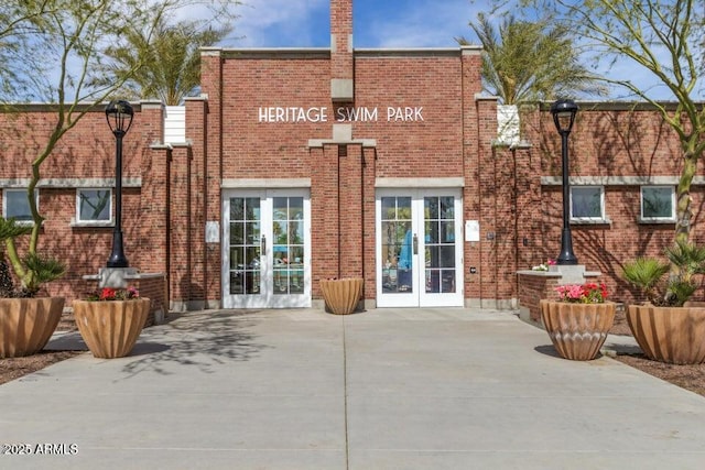 20709 W Delaney Dr, Buckeye, AZ 85396 - back of property with french doors, brick siding, and a patio area