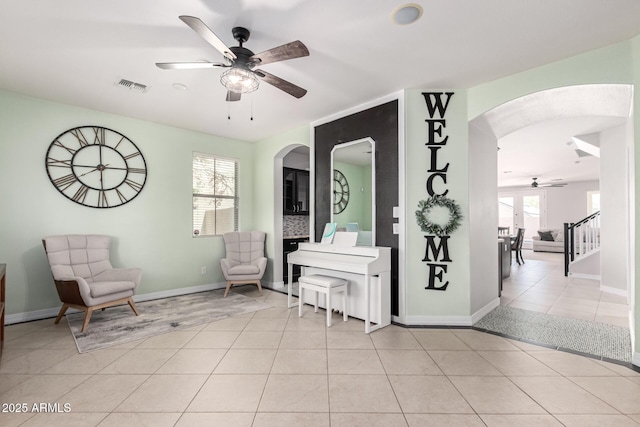 20709 W Delaney Dr, Buckeye, AZ 85396 - sitting room featuring a ceiling fan, arched walkways, and light tile patterned floors