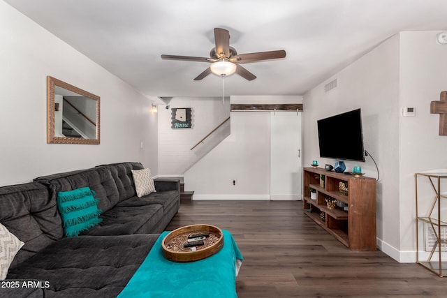 living room with baseboards, ceiling fan, visible vents, and dark wood-style flooring