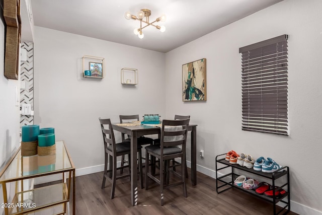 dining space with dark wood-style flooring and baseboards