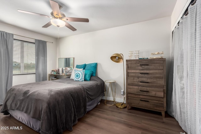 bedroom with ceiling fan and dark hardwood / wood-style floors