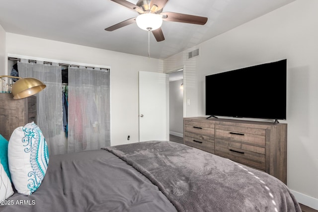 bedroom with ceiling fan, visible vents, and baseboards