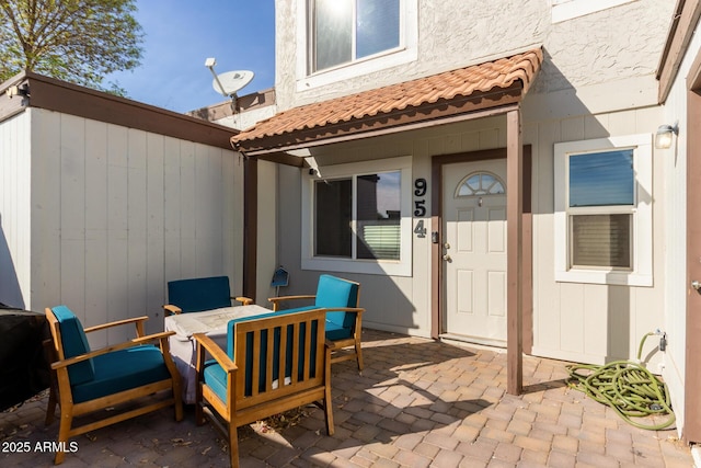 entrance to property featuring a patio area