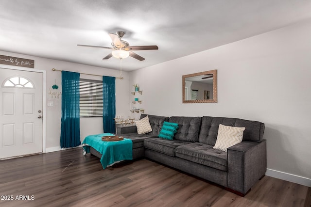 living room with a ceiling fan, baseboards, and dark wood-type flooring