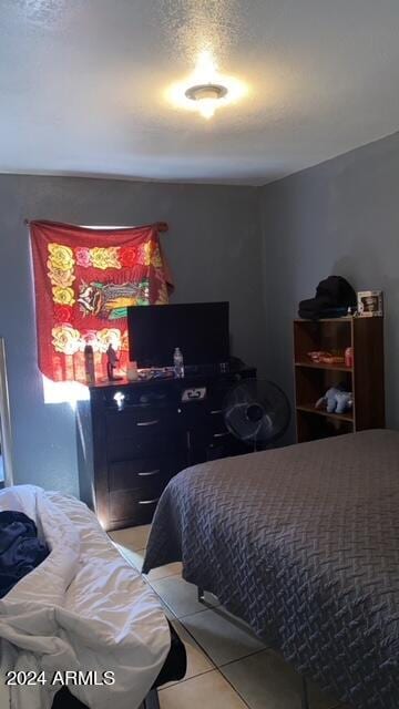 bedroom with tile patterned floors and a textured ceiling