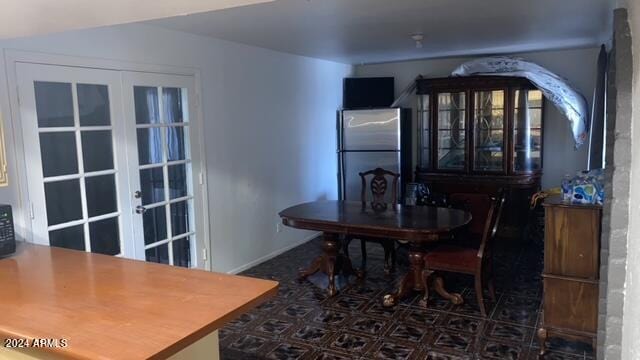 tiled dining room featuring french doors