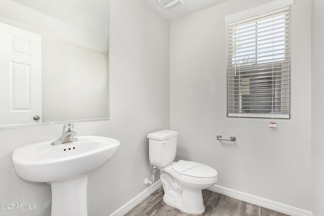 810 E Agua Fria Ln, Avondale, AZ 85323 - half bath featuring toilet, a sink, wood finished floors, baseboards, and visible vents