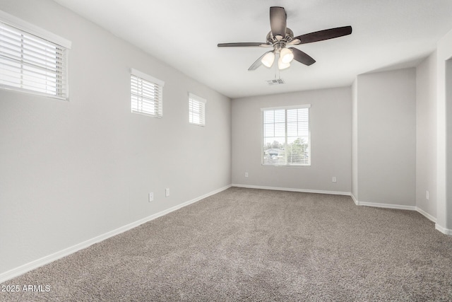 810 E Agua Fria Ln, Avondale, AZ 85323 - spare room featuring carpet flooring, baseboards, ceiling fan, and visible vents
