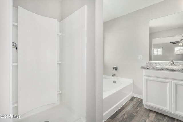 810 E Agua Fria Ln, Avondale, AZ 85323 - full bath featuring walk in shower, ceiling fan, wood finished floors, vanity, and a garden tub