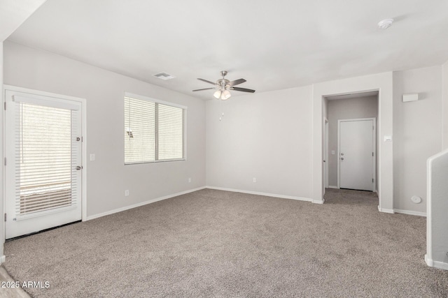 810 E Agua Fria Ln, Avondale, AZ 85323 - unfurnished living room featuring baseboards, visible vents, carpet flooring, and a ceiling fan