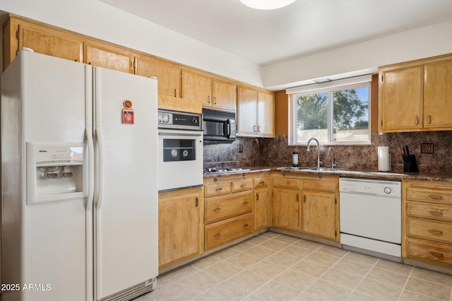 kitchen with light tile patterned flooring, white appliances, tasteful backsplash, and sink