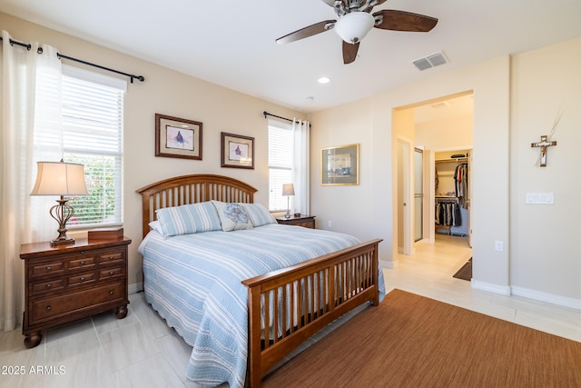 bedroom featuring light tile patterned flooring, a walk in closet, and ceiling fan