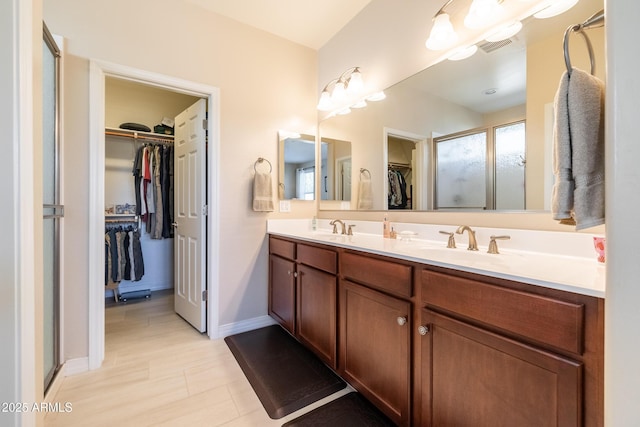 bathroom featuring vanity and a shower with shower door