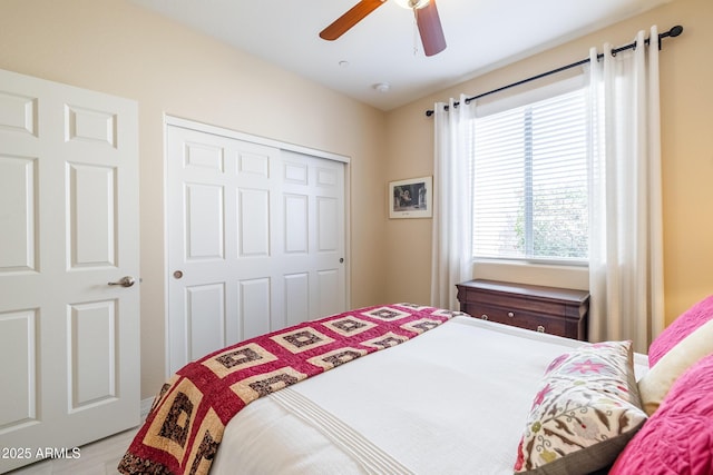 bedroom with ceiling fan and a closet