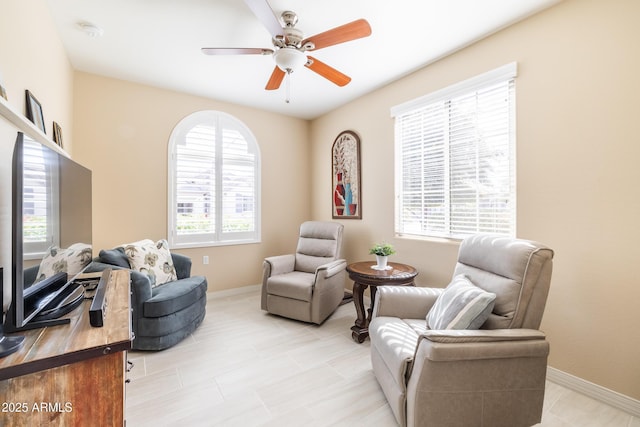 living area featuring ceiling fan