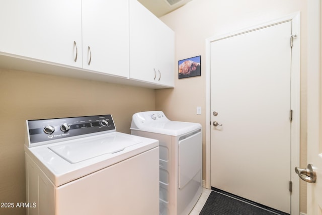 laundry room with cabinets and separate washer and dryer