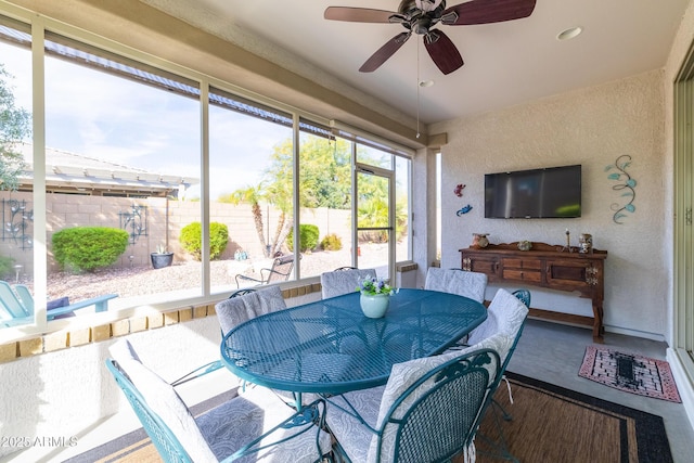 sunroom featuring ceiling fan