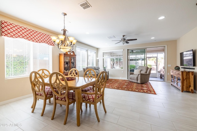 dining room featuring ceiling fan with notable chandelier