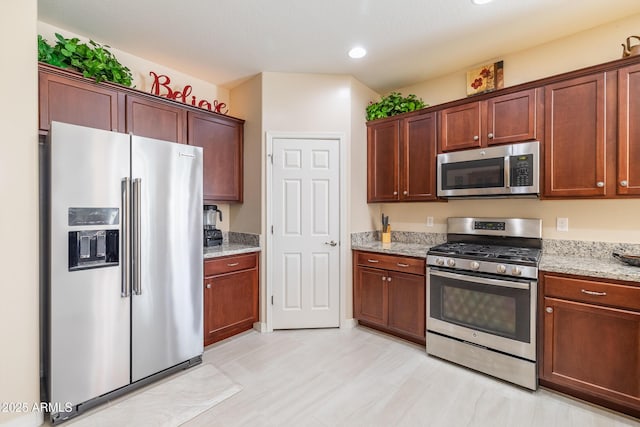 kitchen with light stone counters and stainless steel appliances