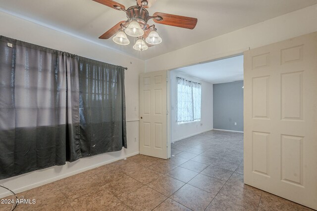 2301 E University Dr Unit 339, Mesa, AZ 85213 - tiled empty room featuring ceiling fan and baseboards