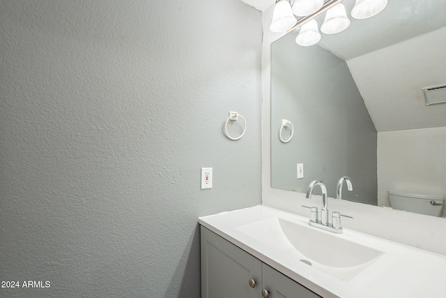2301 E University Dr Unit 339, Mesa, AZ 85213 - half bathroom with lofted ceiling, vanity, and toilet